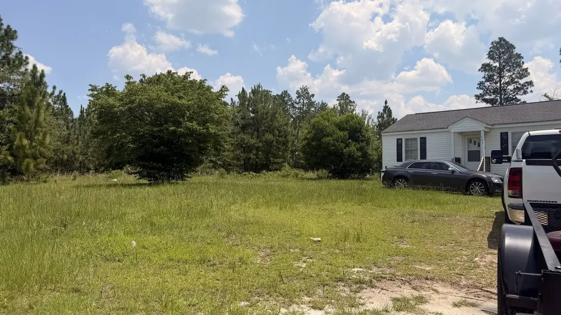 Freshly mowed open lawn beside a home in the Sandhills